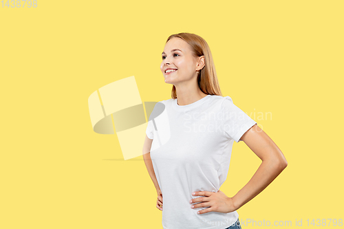 Image of Caucasian young woman\'s half-length portrait on yellow background