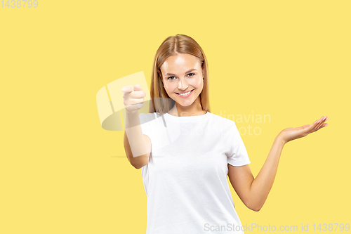 Image of Caucasian young woman\'s half-length portrait on yellow background