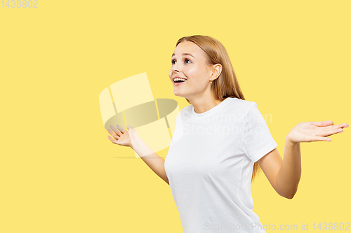 Image of Caucasian young woman\'s half-length portrait on yellow background