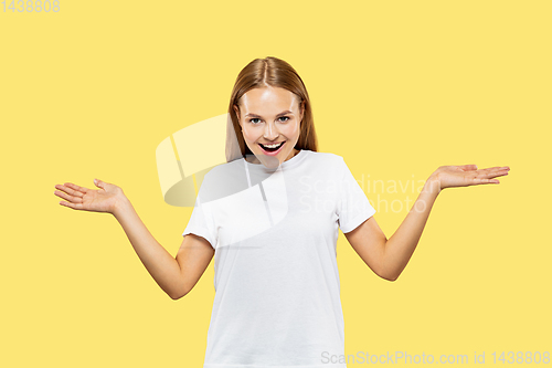 Image of Caucasian young woman\'s half-length portrait on yellow background