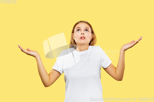 Image of Caucasian young woman\'s half-length portrait on yellow background