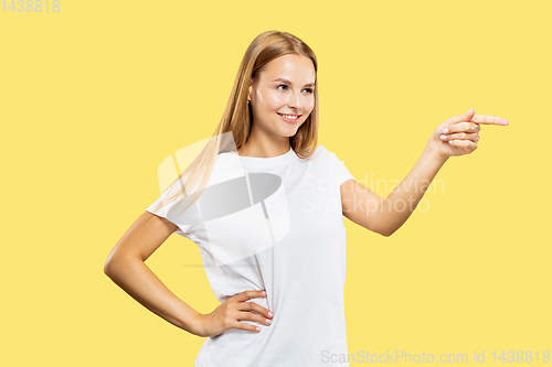 Image of Caucasian young woman\'s half-length portrait on yellow background