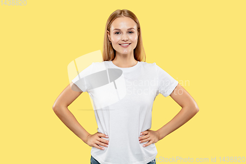 Image of Caucasian young woman\'s half-length portrait on yellow background