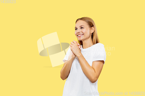 Image of Caucasian young woman\'s half-length portrait on yellow background