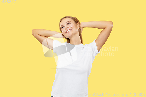 Image of Caucasian young woman\'s half-length portrait on yellow background