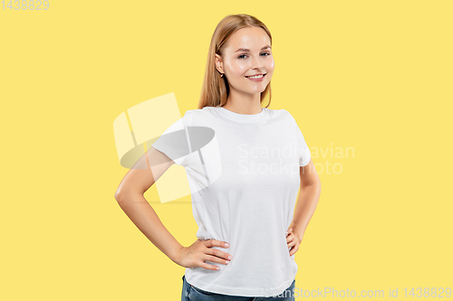 Image of Caucasian young woman\'s half-length portrait on yellow background