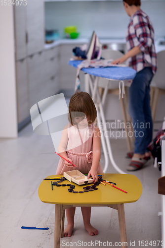 Image of mother and daughter spending time together at home