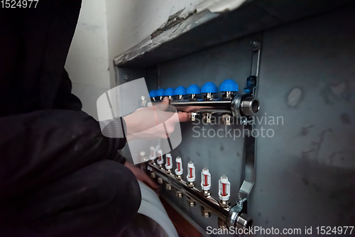 Image of engineer checking technical data of heating system