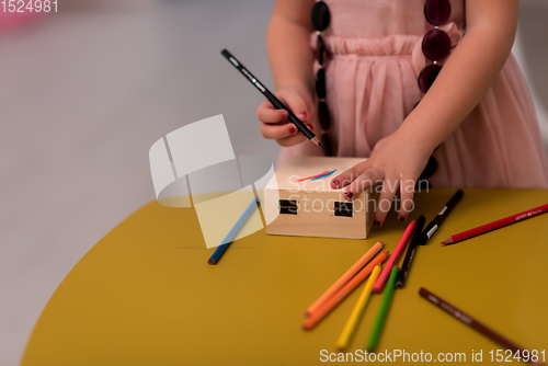 Image of little girl painting jewelry box