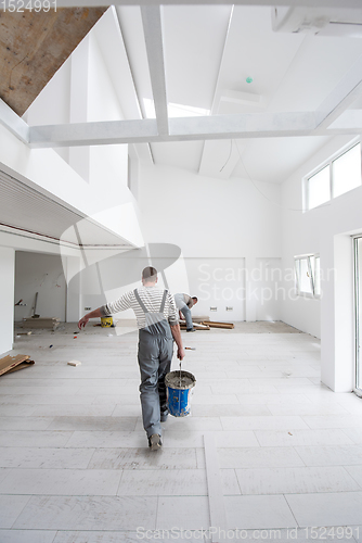 Image of workers installing the ceramic wood effect tiles on the floor