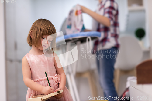 Image of mother and daughter spending time together at home