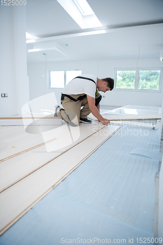 Image of Worker Installing New Laminated Wooden Floor