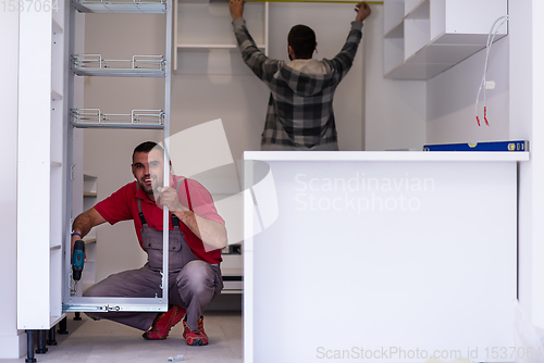 Image of workers installing a new kitchen