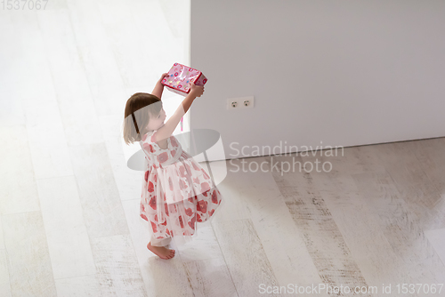 Image of little girl enjoying while playing with mother\'s jewelry