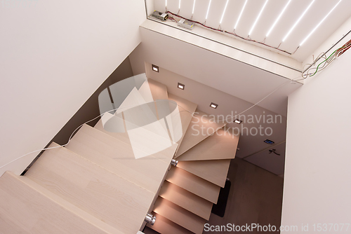 Image of stylish interior with wooden stairs