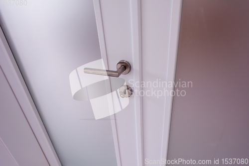 Image of double glass door with white wooden frame