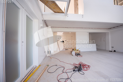 Image of carpenters installing glass door with a wooden frame