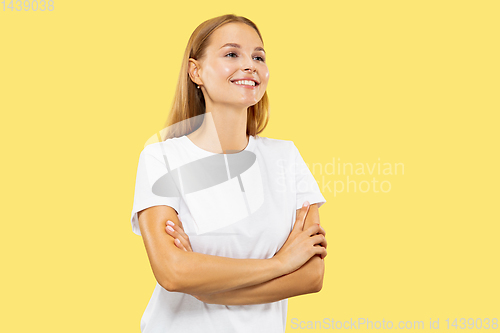 Image of Caucasian young woman\'s half-length portrait on yellow background