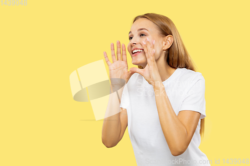 Image of Caucasian young woman\'s half-length portrait on yellow background
