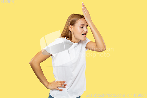 Image of Caucasian young woman\'s half-length portrait on yellow background