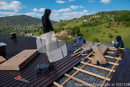 Image of Construction worker installing a new roof