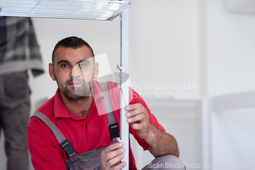 Image of worker installing a new kitchen