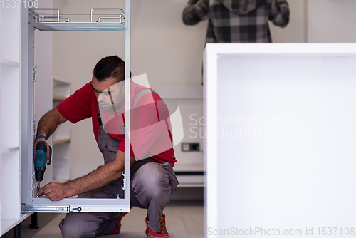 Image of workers installing a new kitchen