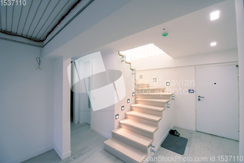 Image of stylish interior with wooden stairs
