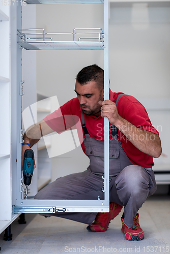 Image of worker installing a new kitchen