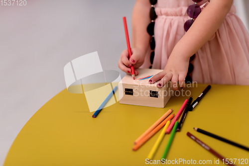 Image of little girl painting jewelry box