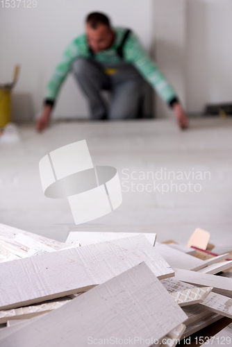 Image of worker installing the ceramic wood effect tiles on the floor