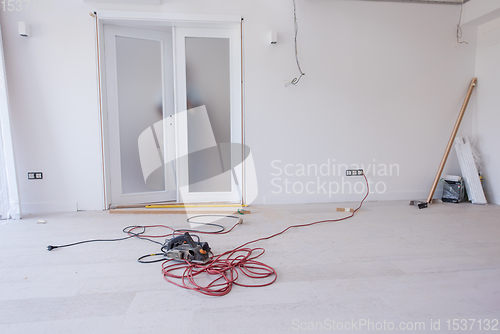 Image of carpenters installing glass door with a wooden frame