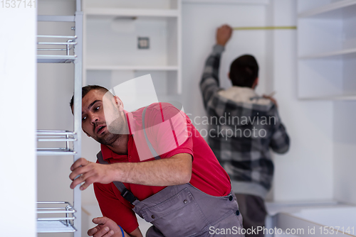 Image of workers installing a new kitchen