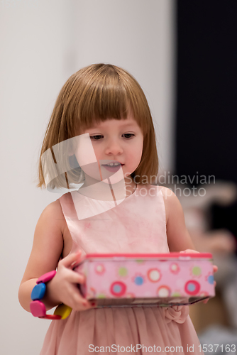 Image of little girl enjoying while playing with mother\'s jewelry