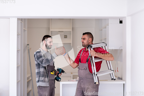 Image of workers giving high five to each other