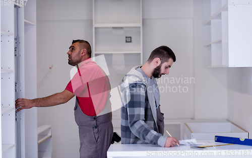 Image of workers installing a new kitchen