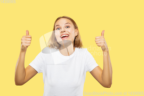 Image of Caucasian young woman\'s half-length portrait on yellow background