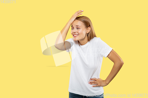 Image of Caucasian young woman\'s half-length portrait on yellow background