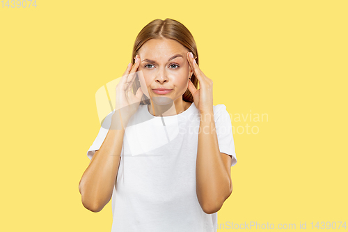Image of Caucasian young woman\'s half-length portrait on yellow background