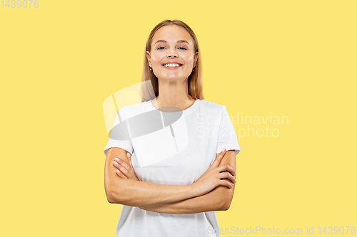 Image of Caucasian young woman\'s half-length portrait on yellow background