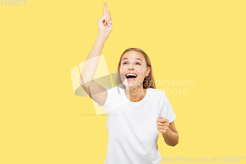 Image of Caucasian young woman\'s half-length portrait on yellow background