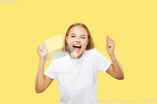 Image of Caucasian young woman\'s half-length portrait on yellow background