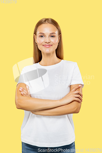 Image of Caucasian young woman\'s half-length portrait on yellow background