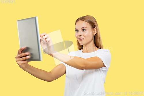 Image of Caucasian young woman\'s half-length portrait on yellow background