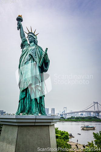 Image of Statue of liberty and tokyo cityscape, Japan