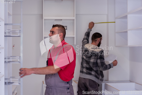 Image of workers installing a new kitchen