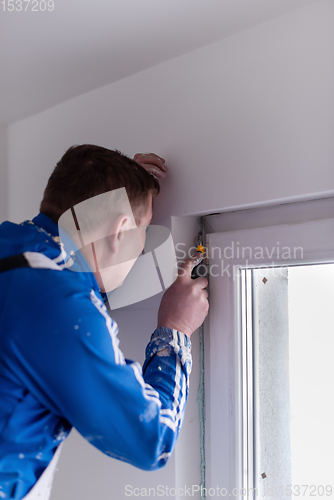 Image of construction worker plastering on gypsum walls