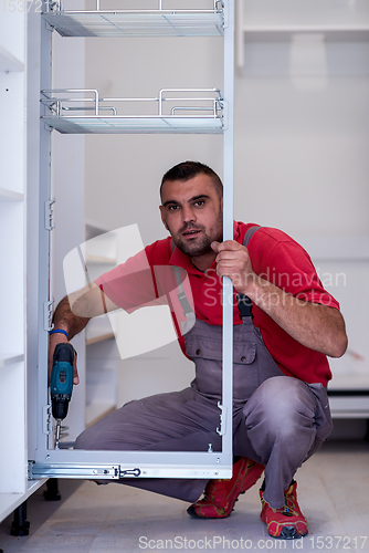 Image of worker installing a new kitchen