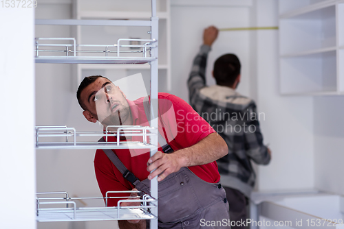 Image of workers installing a new kitchen