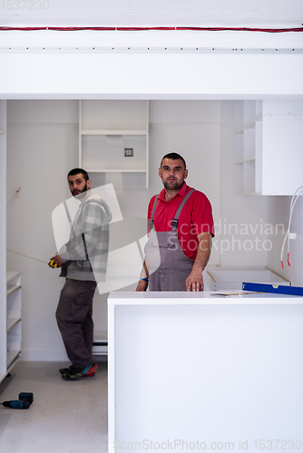 Image of workers installing a new kitchen